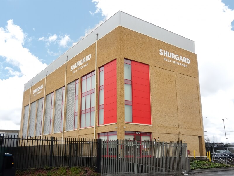 A large brick-clad building and a sign indicating "Shurgard Self Storage."